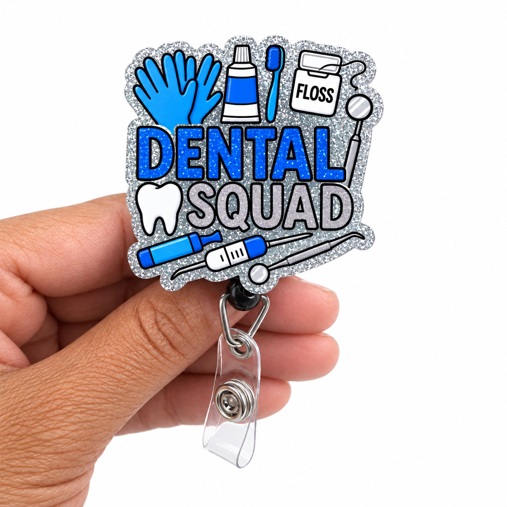 A hand holding a glittery blue 'Dental Squad' badge reel. The badge features a die-cut design with dental icons and text in shades of blue, silver, and white, attached to a clear plastic swivel clip.