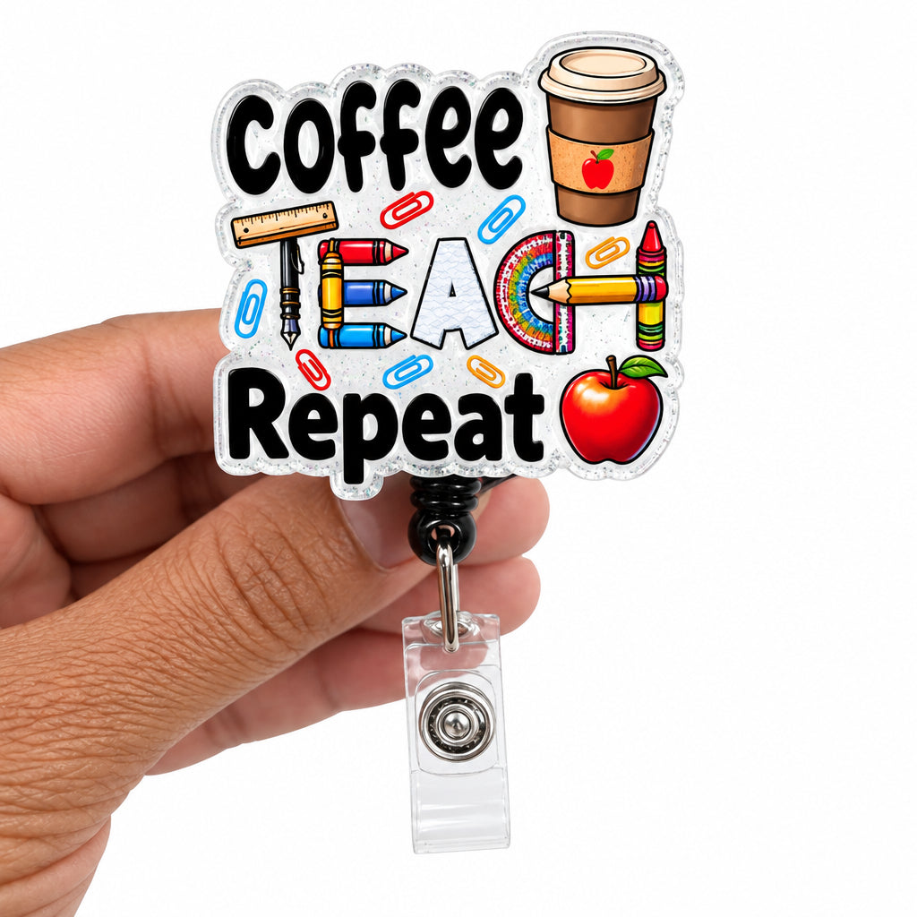 A hand holding a die-cut acrylic badge reel featuring the words 'Coffee Teach Repeat' with school-themed illustrations including pencils, a coffee cup, and an apple, attached to a clear plastic clip.