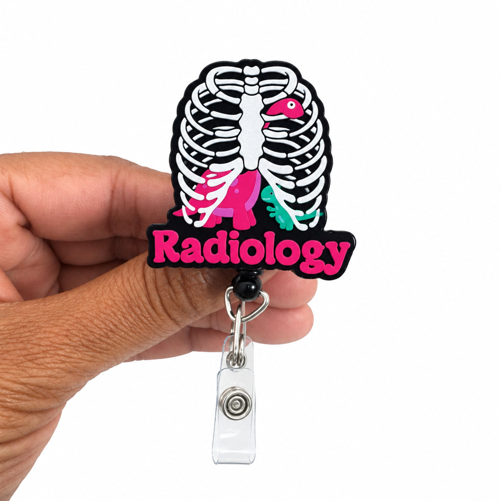 A hand holding a radiology-themed retractable badge reel. The badge has a black and white rib cage design with a pink bird and the word 'Radiology' in pink text.