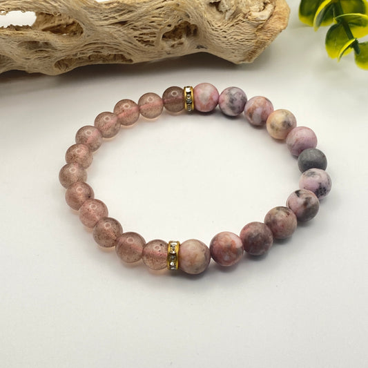 Beaded bracelet with purple and brown stones on a white surface