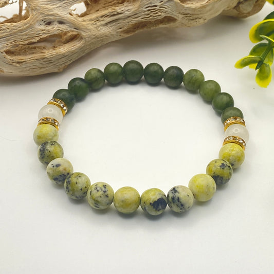 Beaded bracelet with green and white stones on a white background