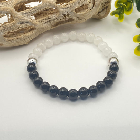 Bracelet with black and white beads on a light background