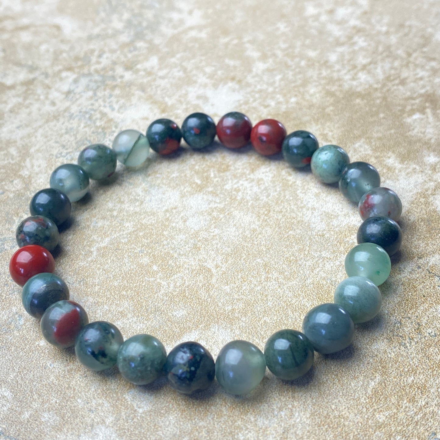 Multicolored beaded bracelet on a textured beige surface