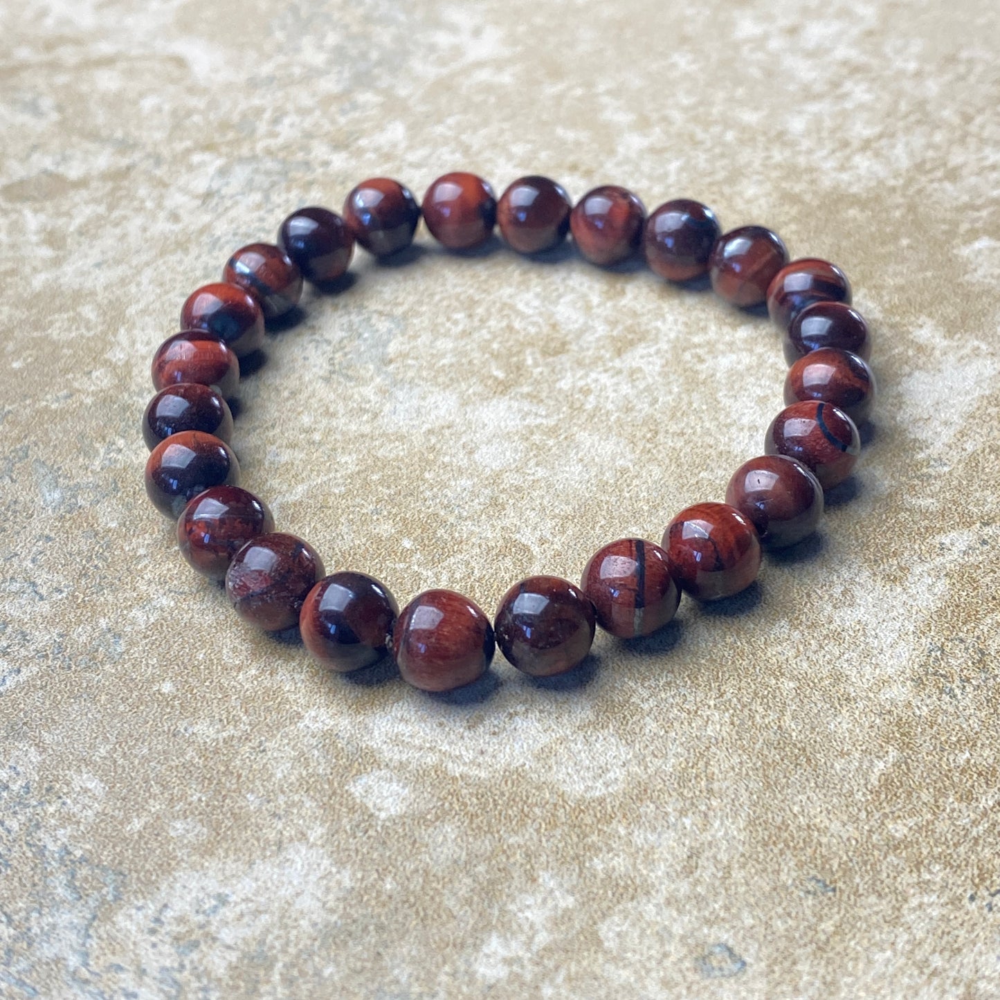 Brown beaded bracelet on a textured surface