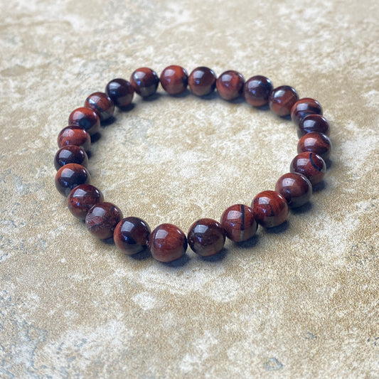 Brown beaded bracelet on a textured surface
