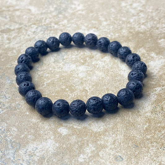 Lava stone bracelet on a textured surface