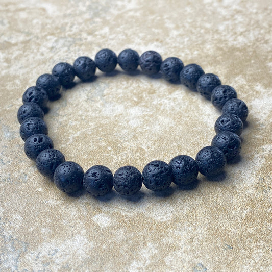 Lava stone bracelet on a textured beige surface