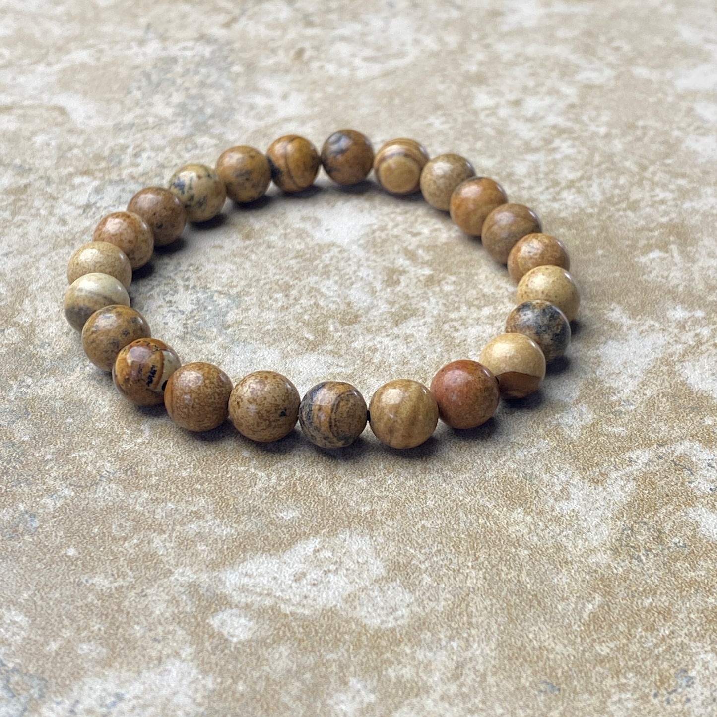 Beaded bracelet on a textured beige surface