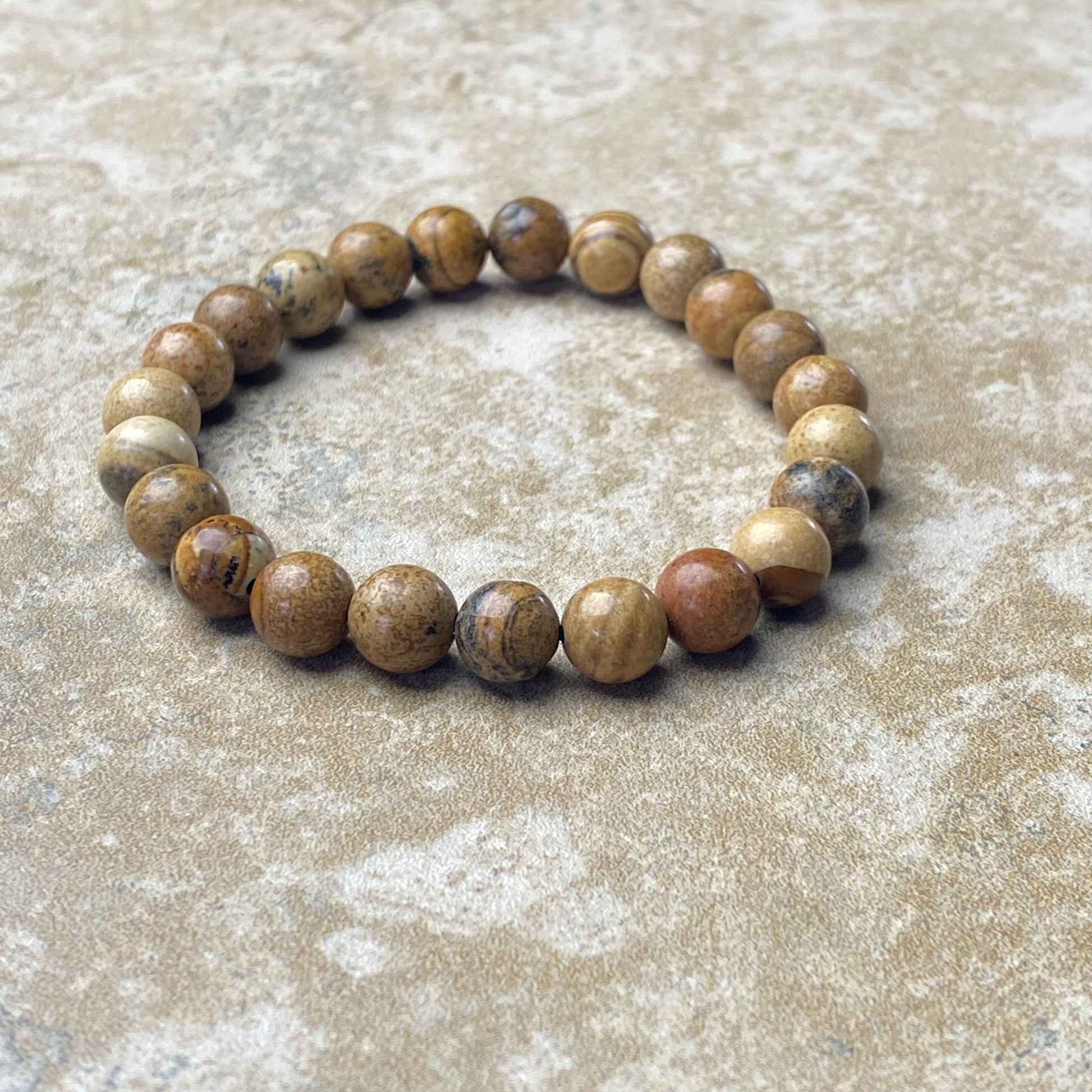 Beaded bracelet on a textured beige surface