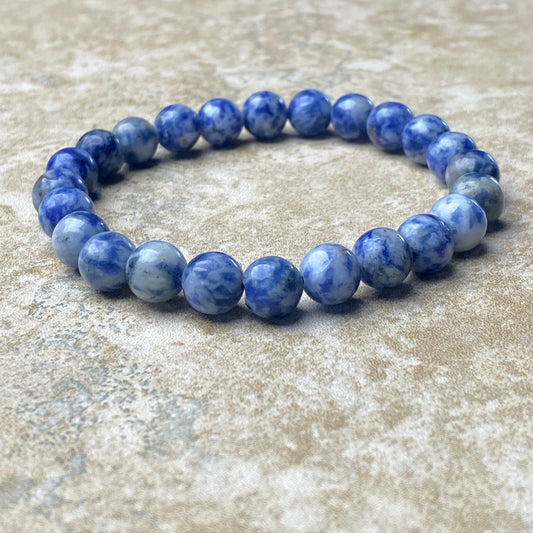 Blue beaded bracelet on a textured surface