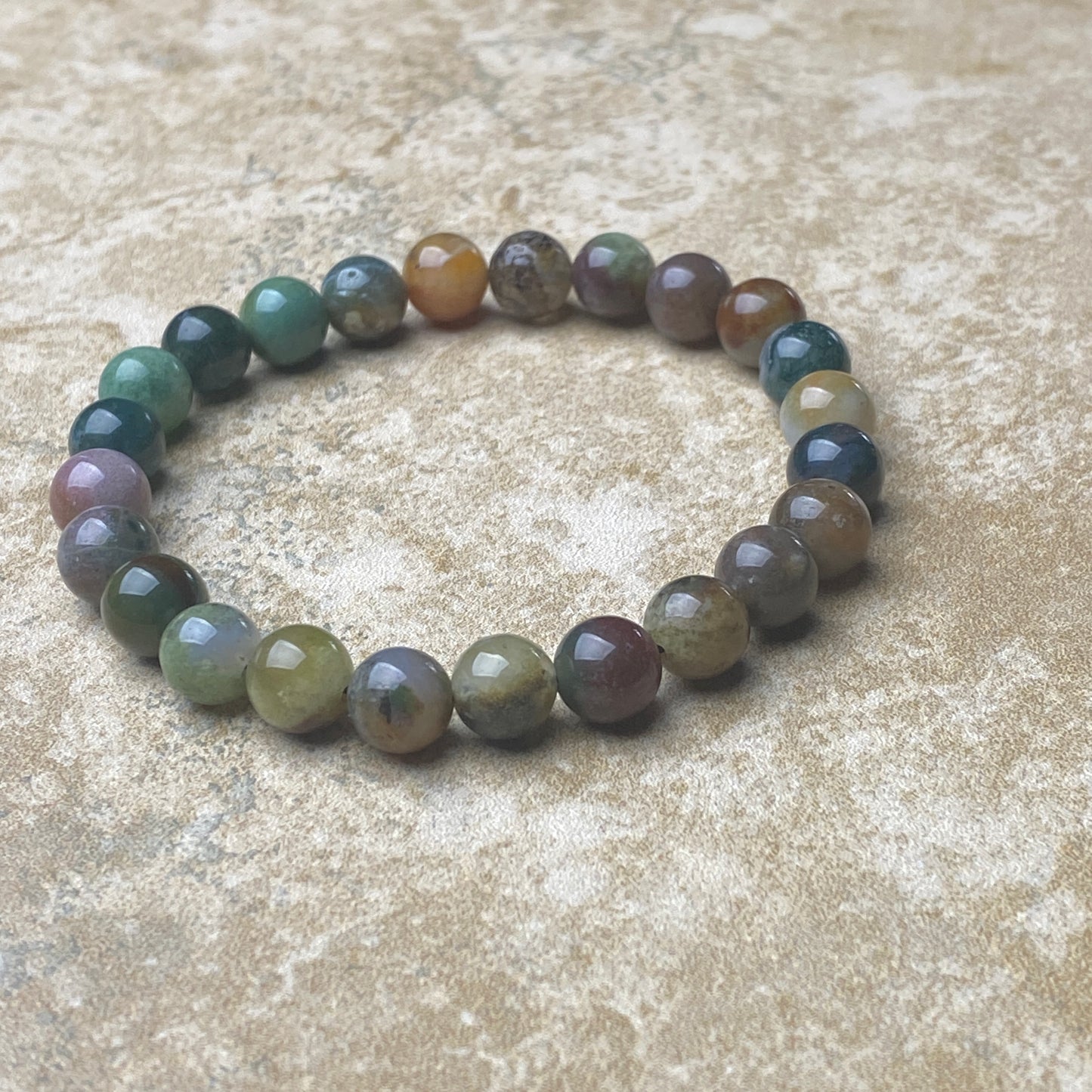 Multicolored beaded bracelet on a textured surface