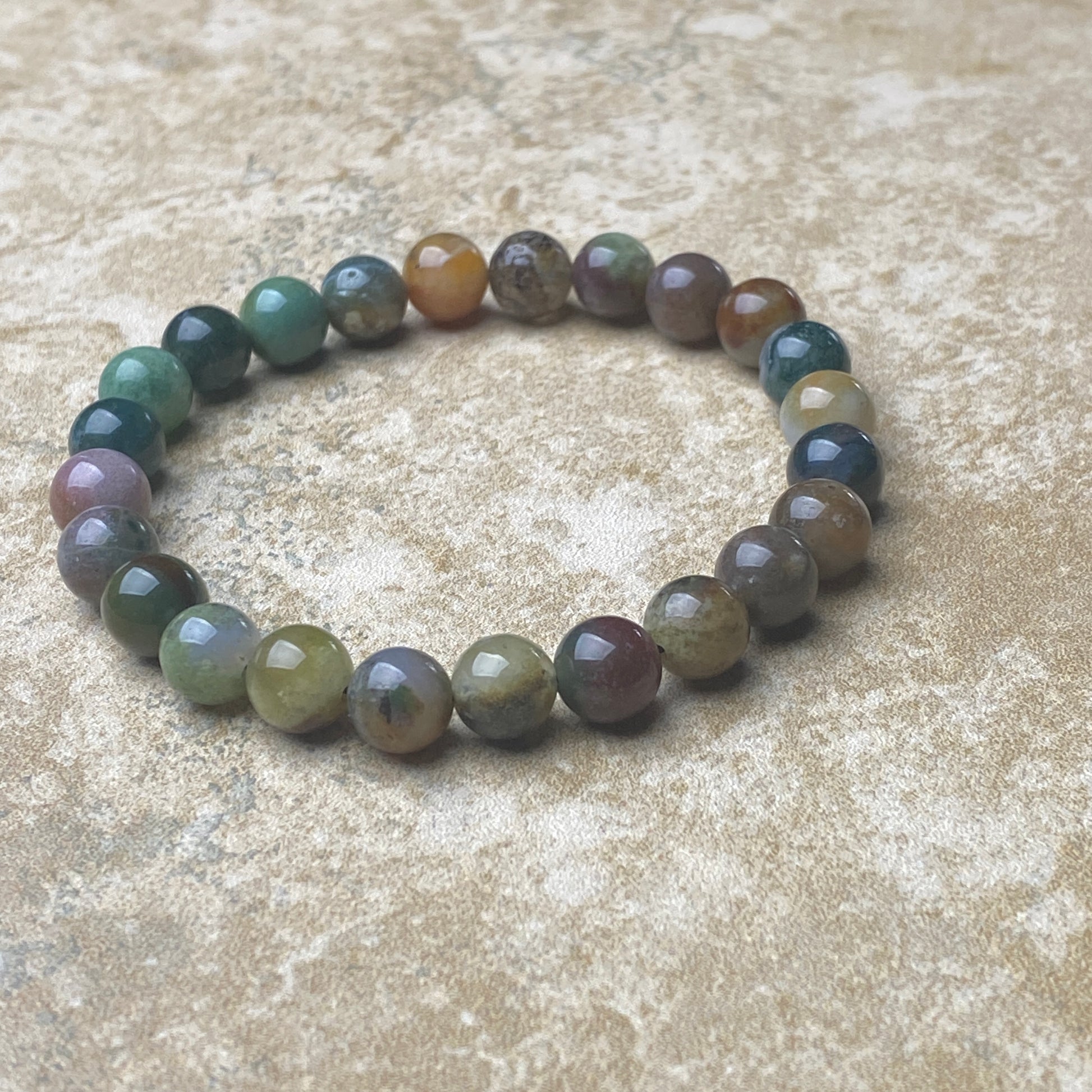 Multicolored beaded bracelet on a textured surface