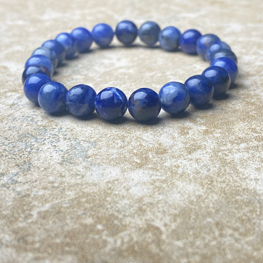 Blue beaded bracelet on a textured surface