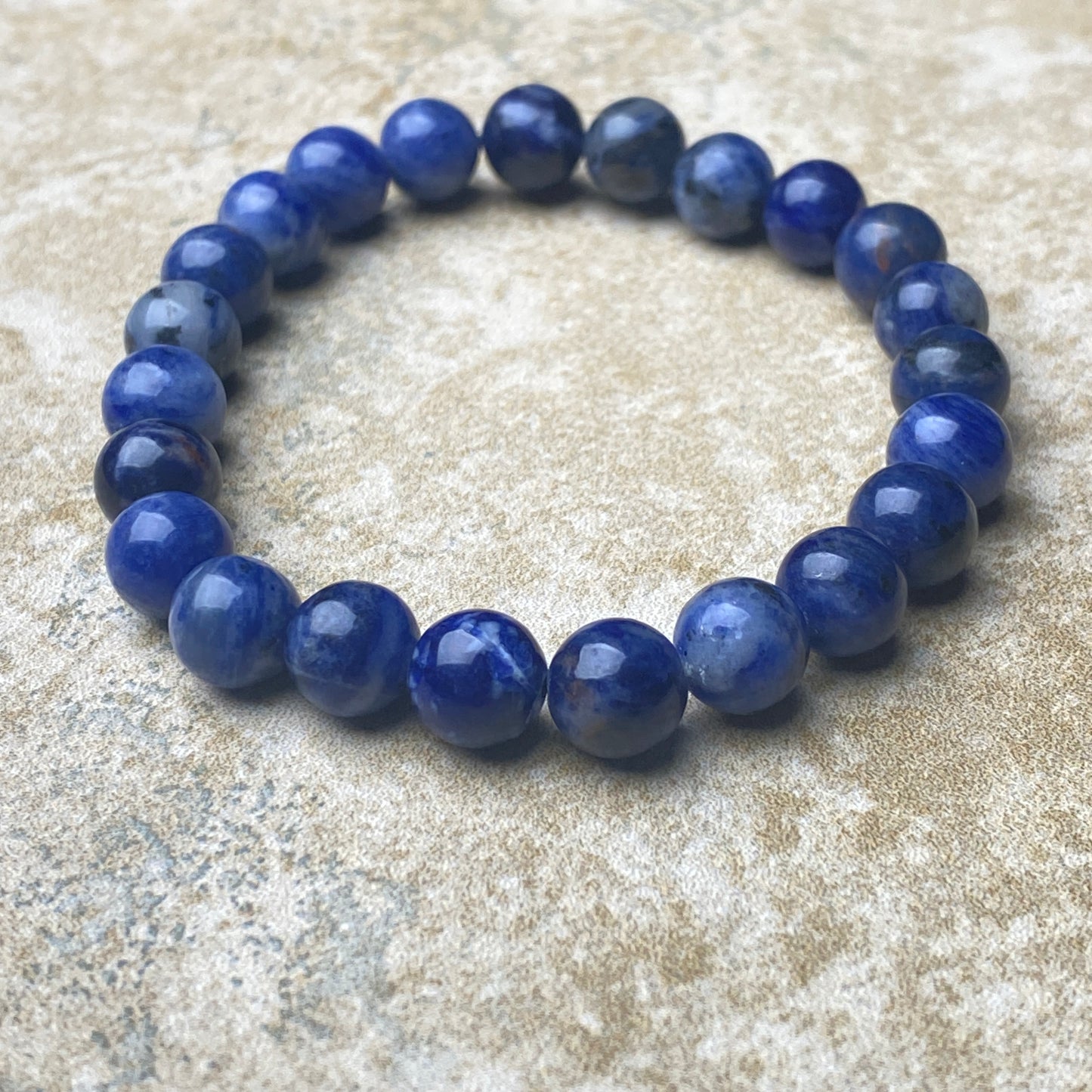 Blue beaded bracelet on a textured surface