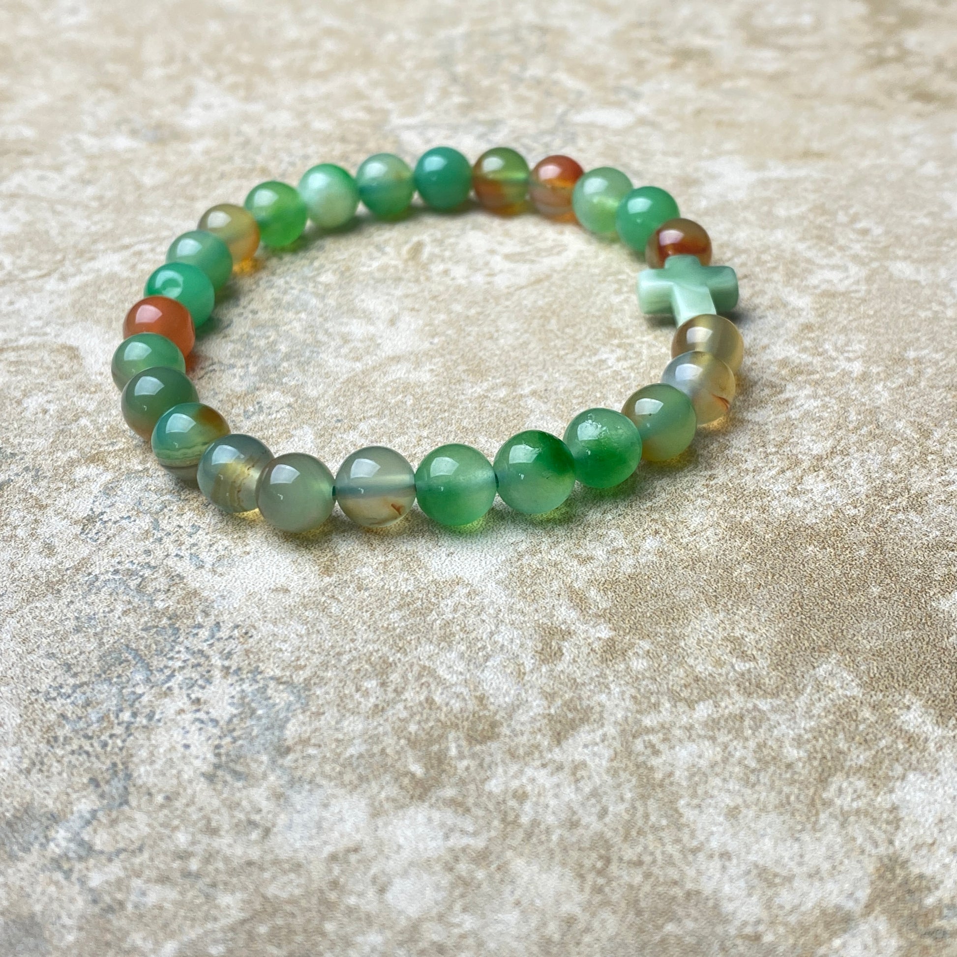 Green beaded bracelet on a textured surface