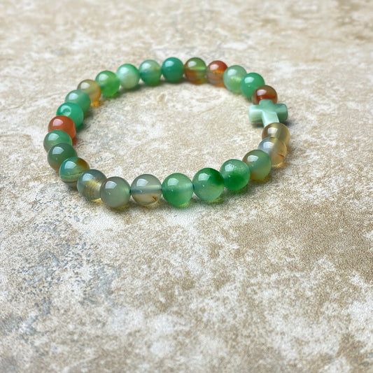 Green beaded bracelet on a textured surface