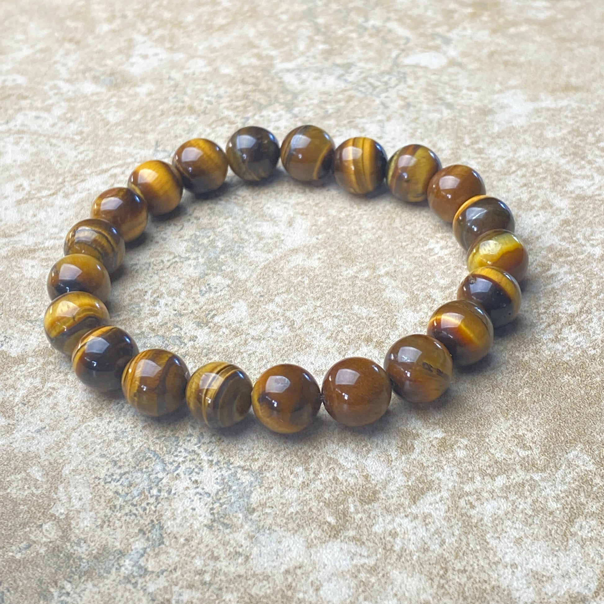 Tiger eye beaded bracelet on a textured surface