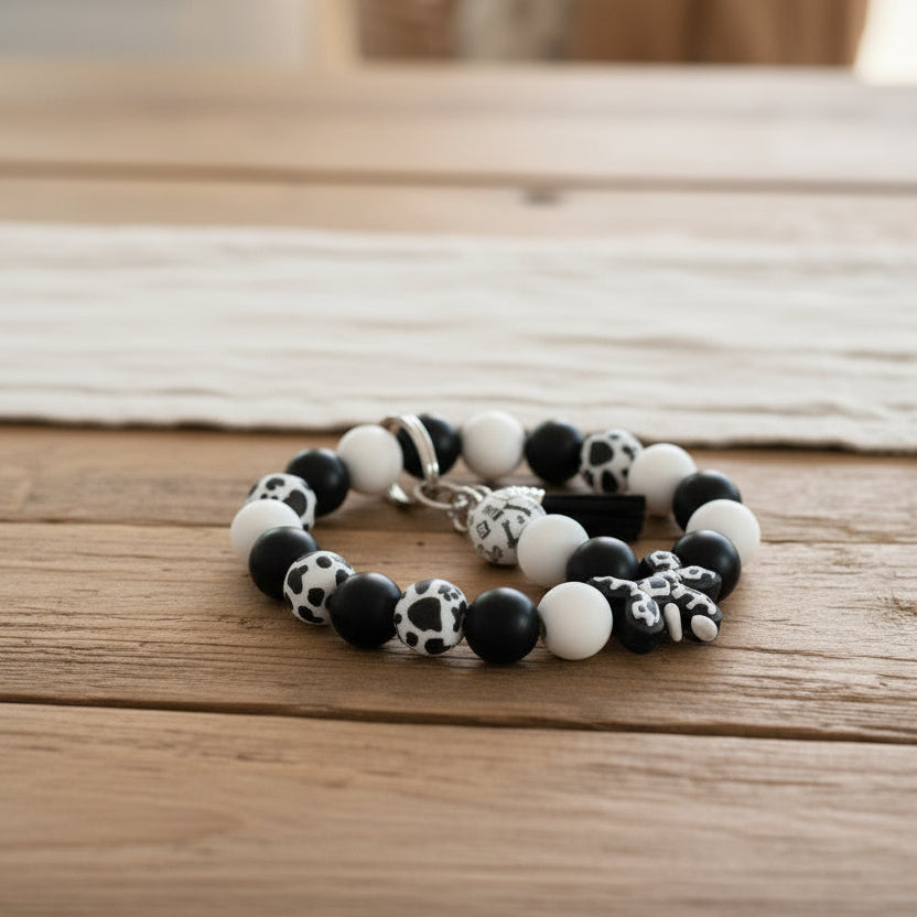 Black and white beaded bracelet on a wooden surface