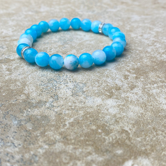 Blue beaded bracelet on a textured surface