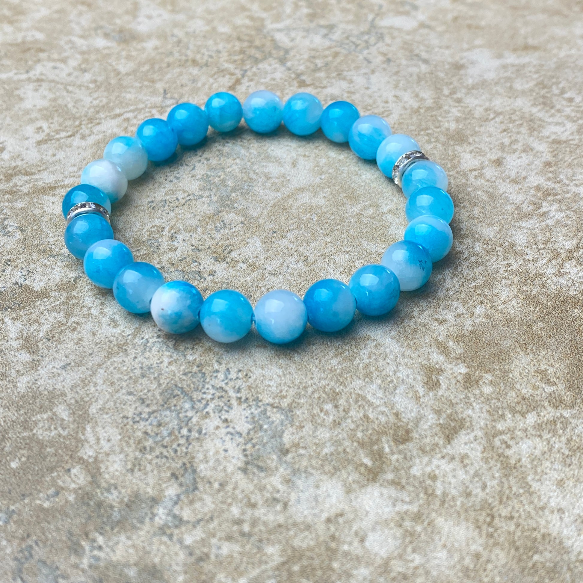 Blue beaded bracelet on a textured surface