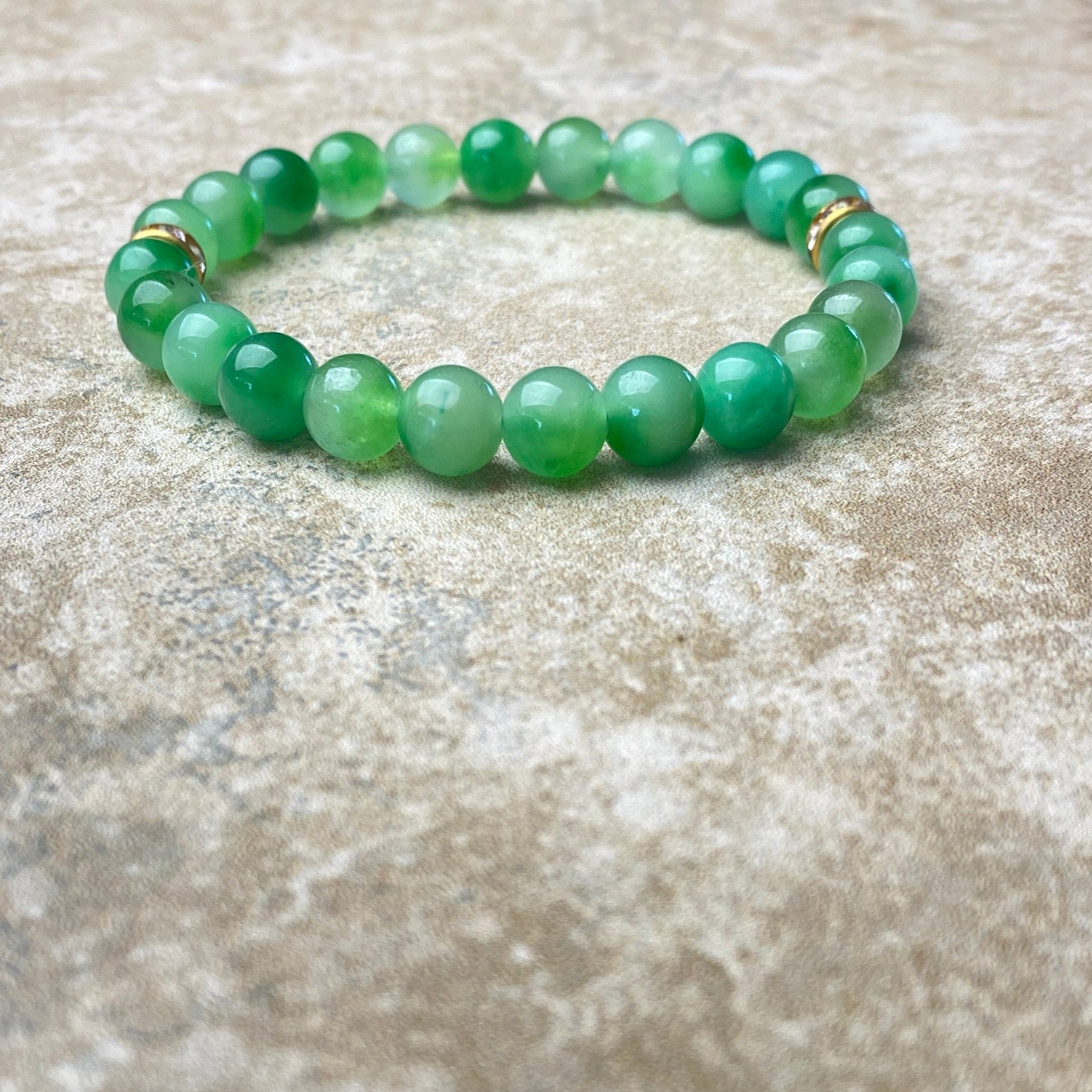 Green beaded bracelet on a textured surface