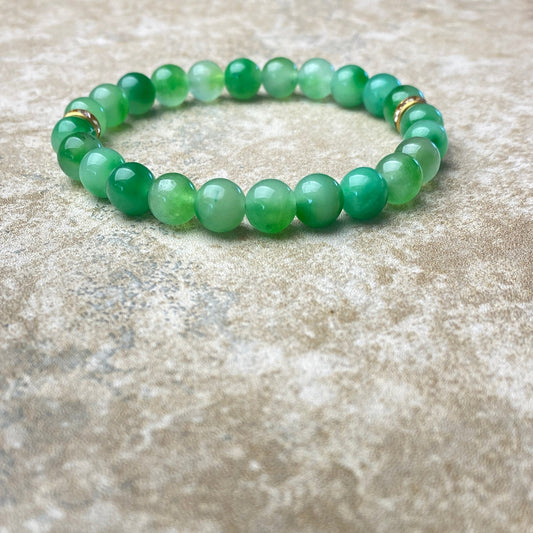 Green beaded bracelet on a textured surface
