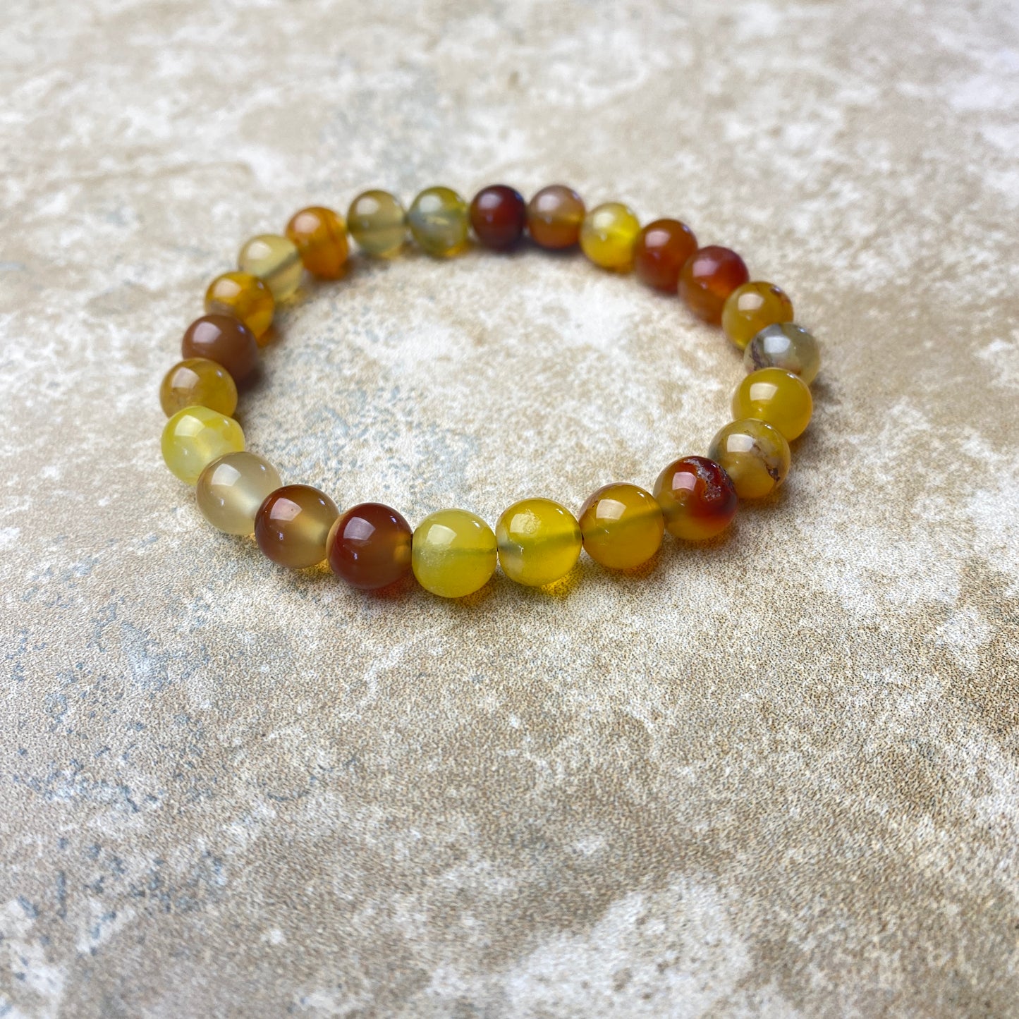 Multicolored beaded bracelet on a textured surface