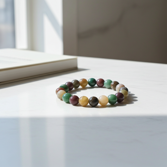 Multicolored beaded bracelet on a light surface with a window in the background