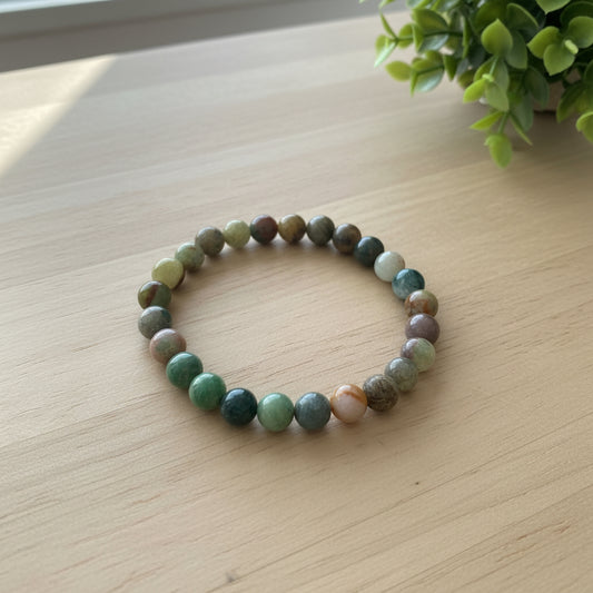 Multicolored beaded bracelet on a wooden surface