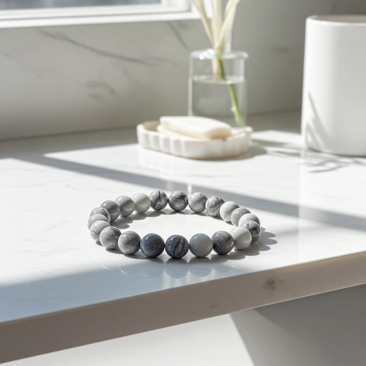 Marble-patterned bracelet on a white surface with a light background