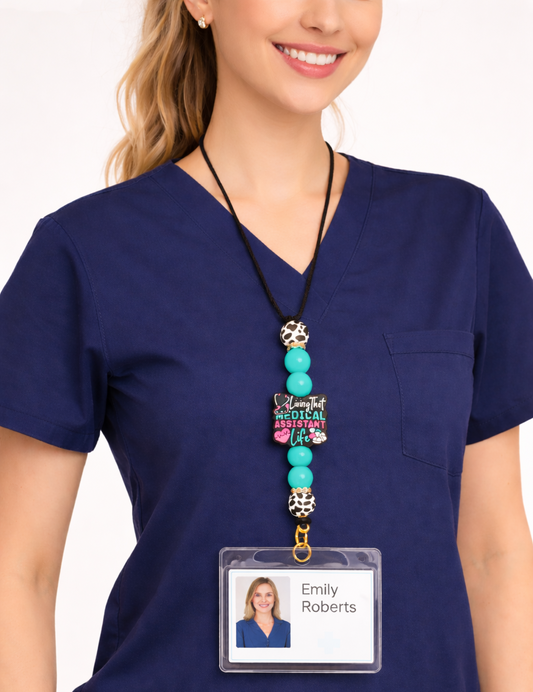 Person wearing a blue scrub top with a decorative lanyard and name badge holder.
