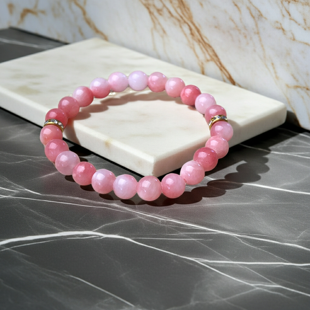 Pink beaded bracelet on a marble surface