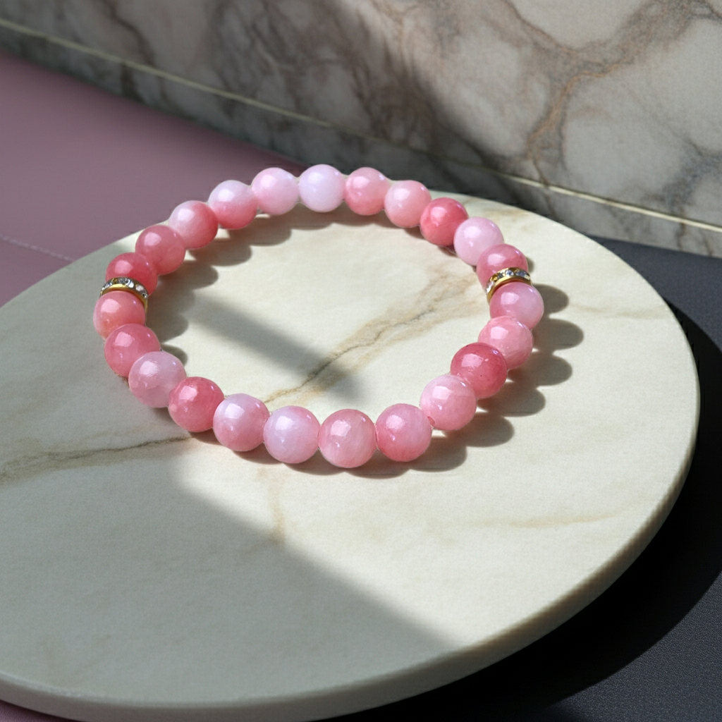 Pink beaded bracelet on a marble surface