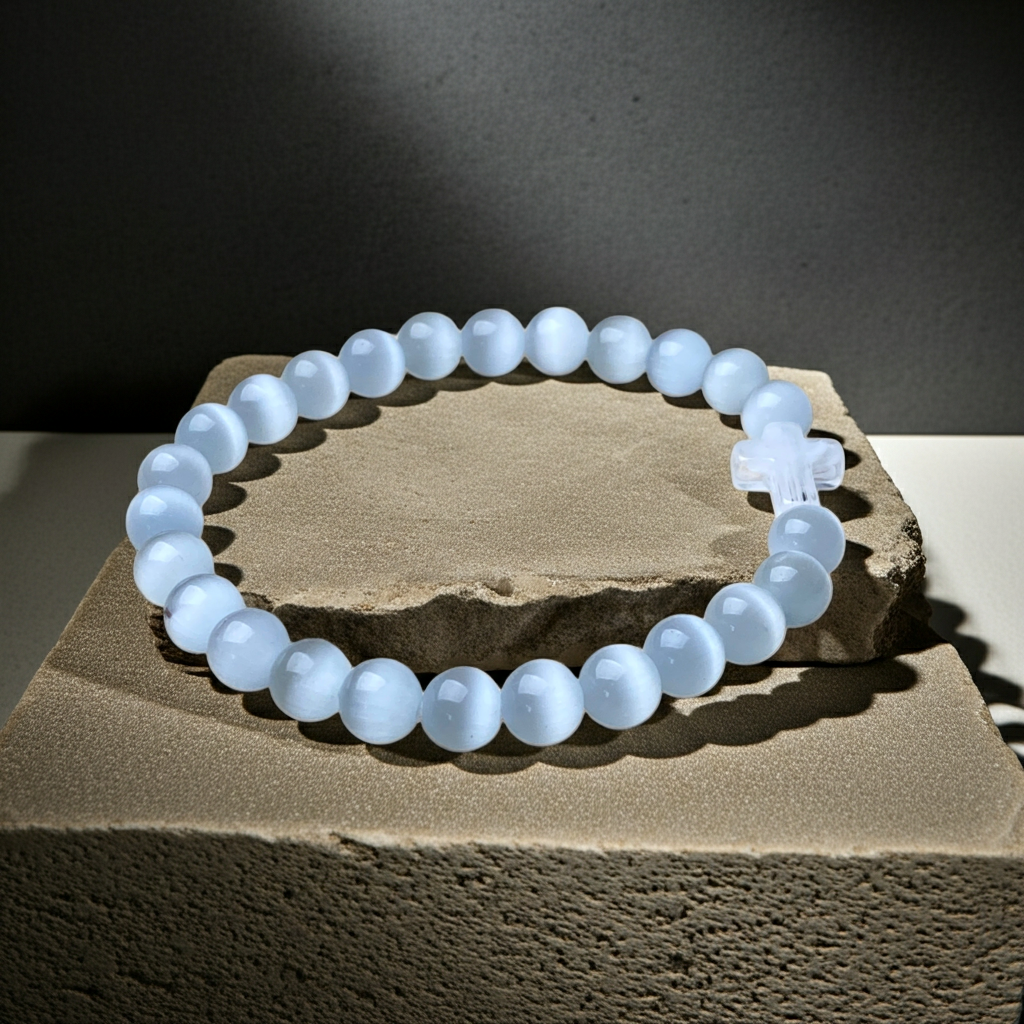 white beaded bracelet on a stone surface with a dark background
