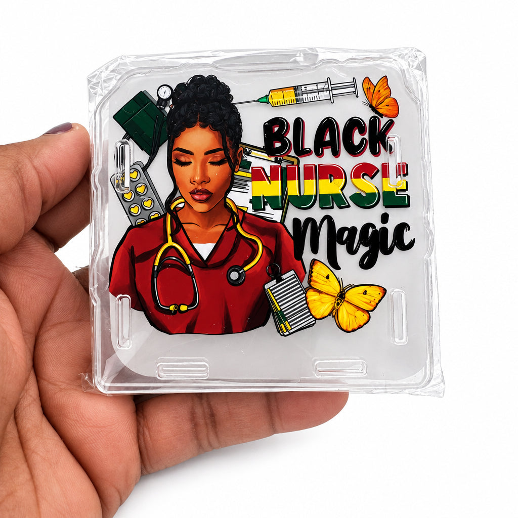 A hand holds a clear plastic-wrapped square acrylic plaque featuring an illustrated Black nurse with medical tools and the text 'BLACK NURSE Magic' on a white background.