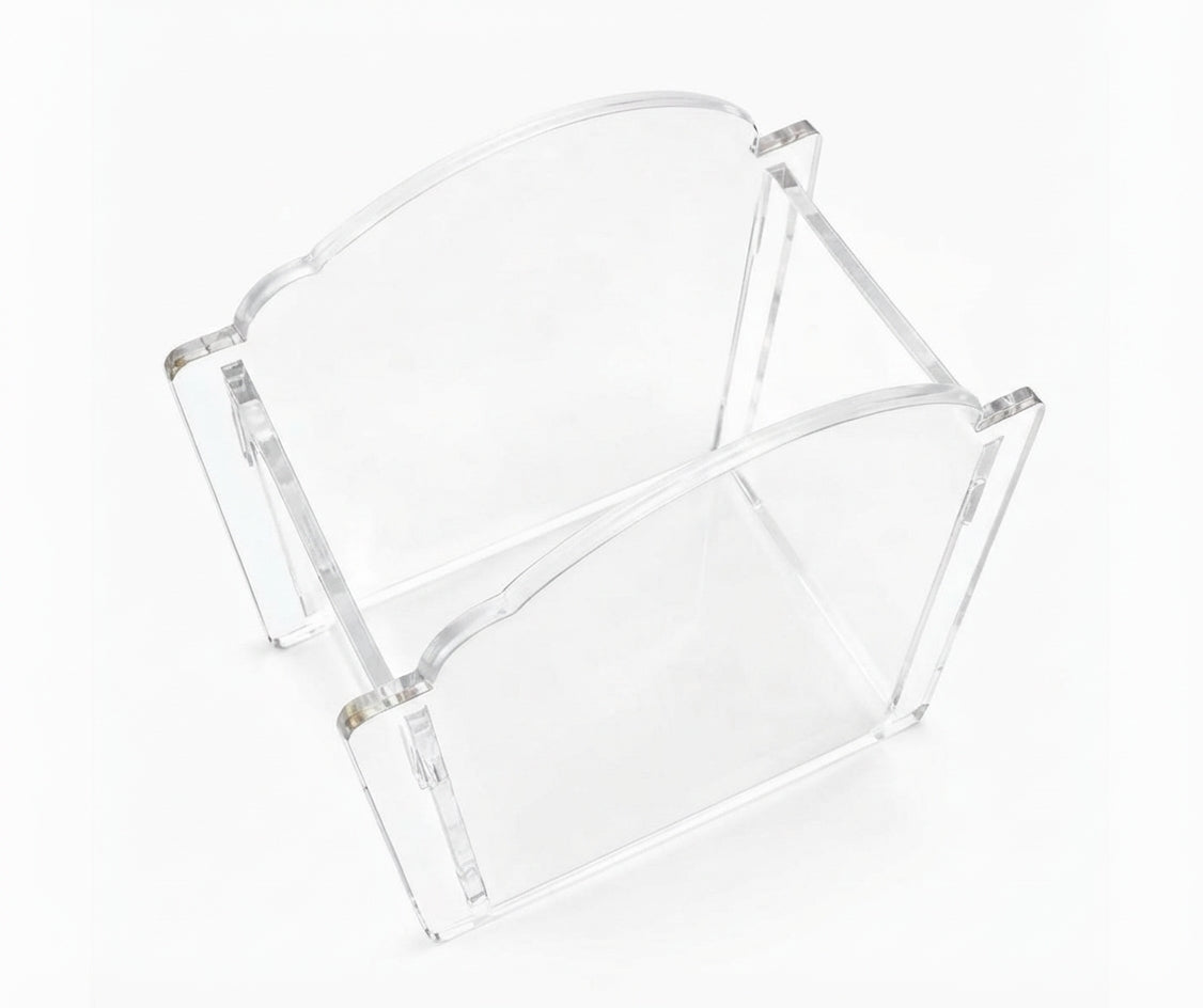 A clear acrylic magazine rack with a modern arched design, shown on a seamless white background.