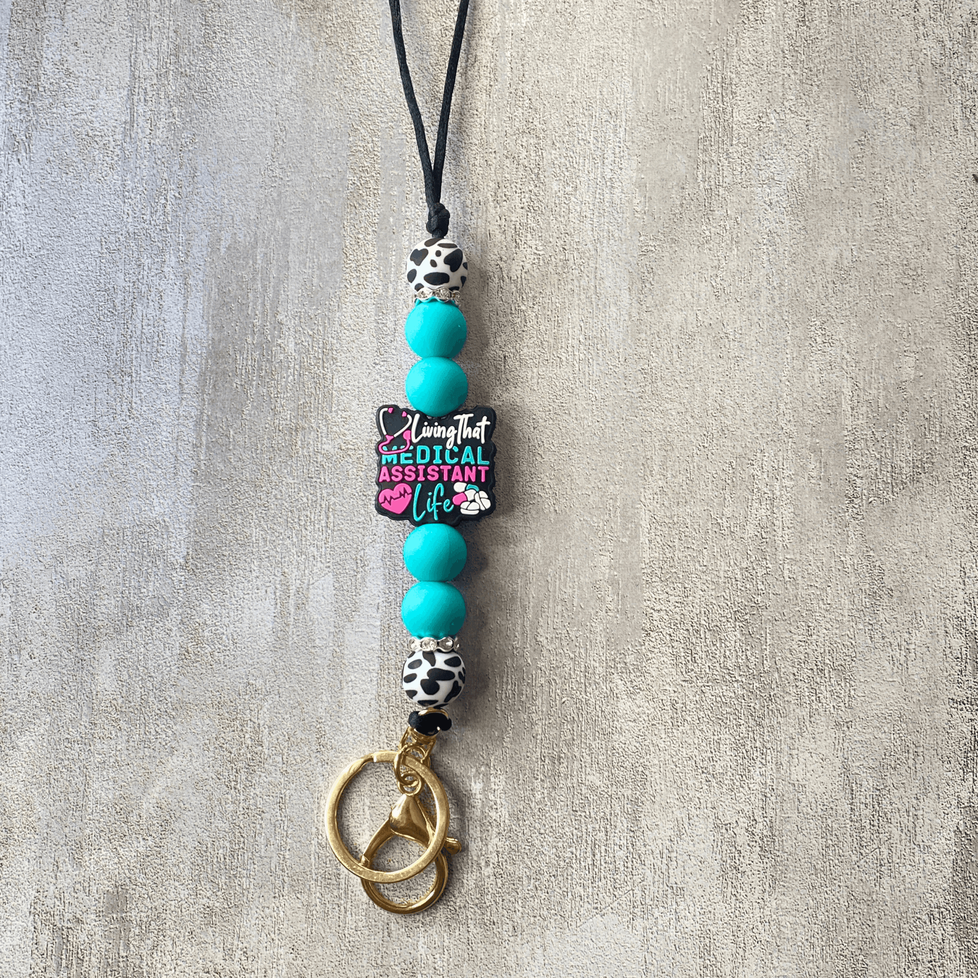Necklace with turquoise beads and a pendant on a textured surface