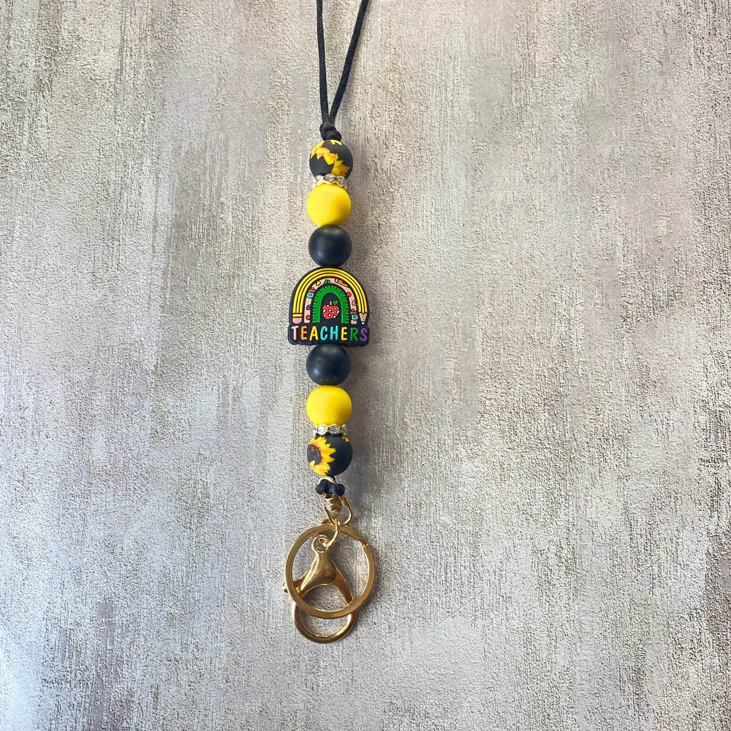 Necklace with colorful beads and a pendant on a textured gray background
